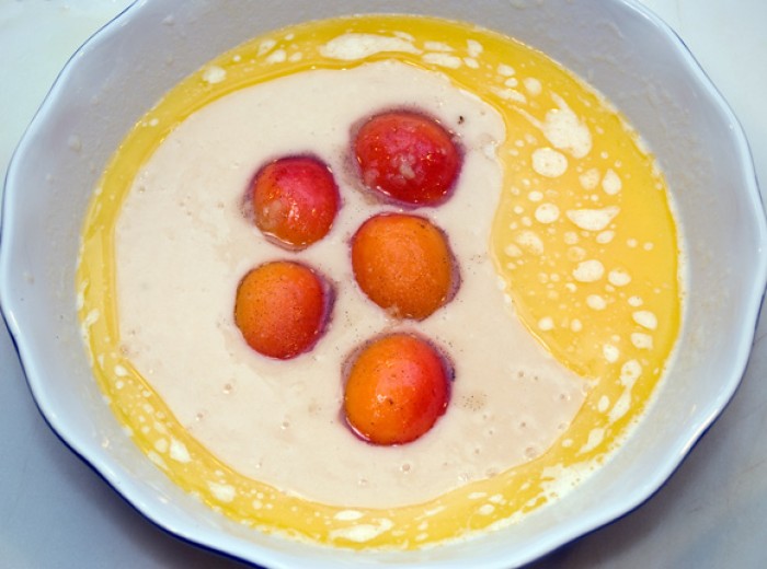 Arranging apricots on cake batter for Apricot Ginger Peasant Cake