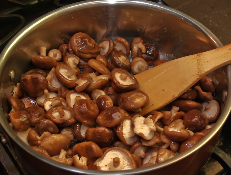 Mushrooms cooking in hte pan