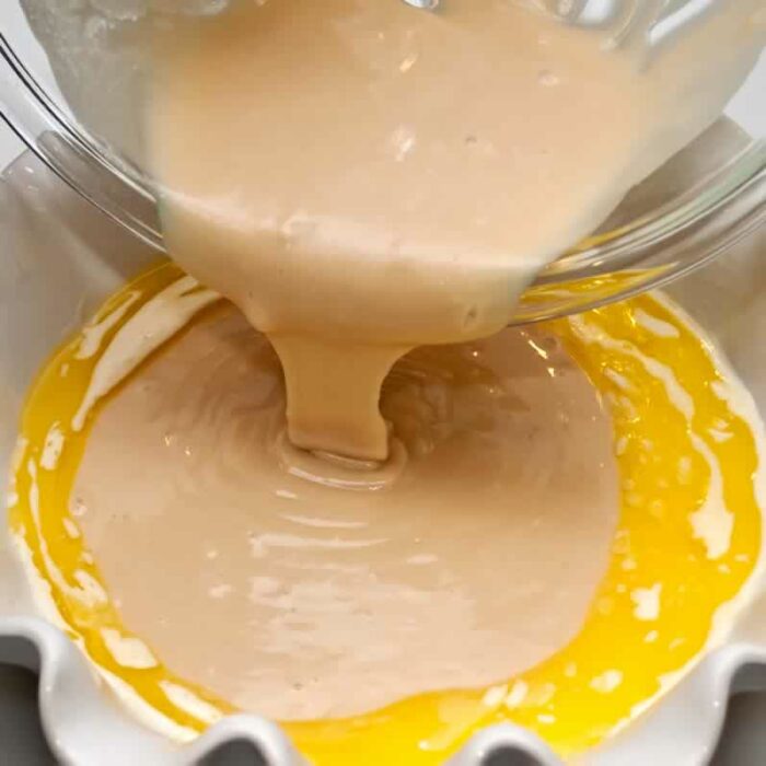 pouring cake batter into pan for Apricot Ginger Peasant Cake