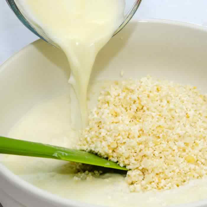 Adding Milk to Arepa Flour and Pureed Corn
